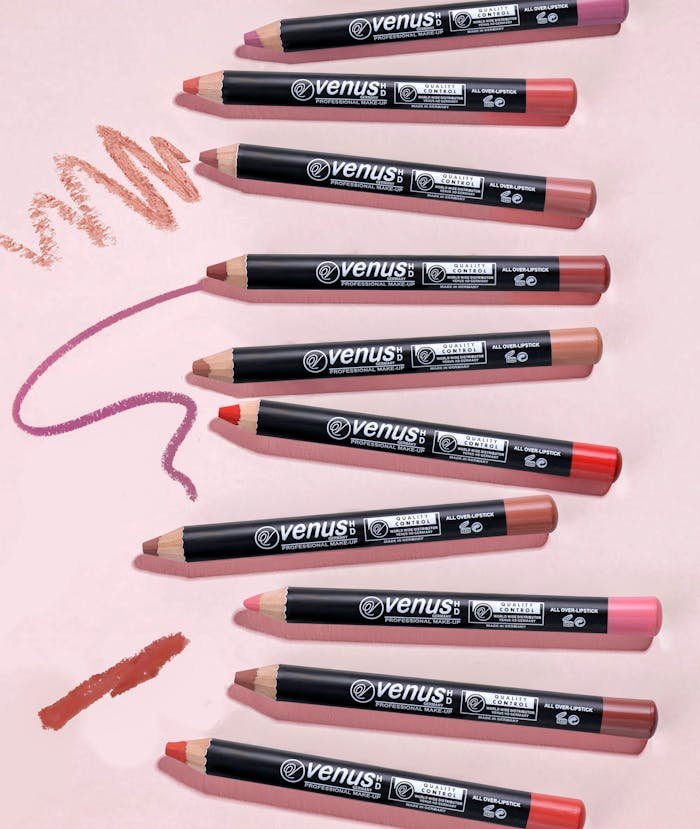 A vibrant display of multi-colored lip pencils arranged on a pink backdrop.